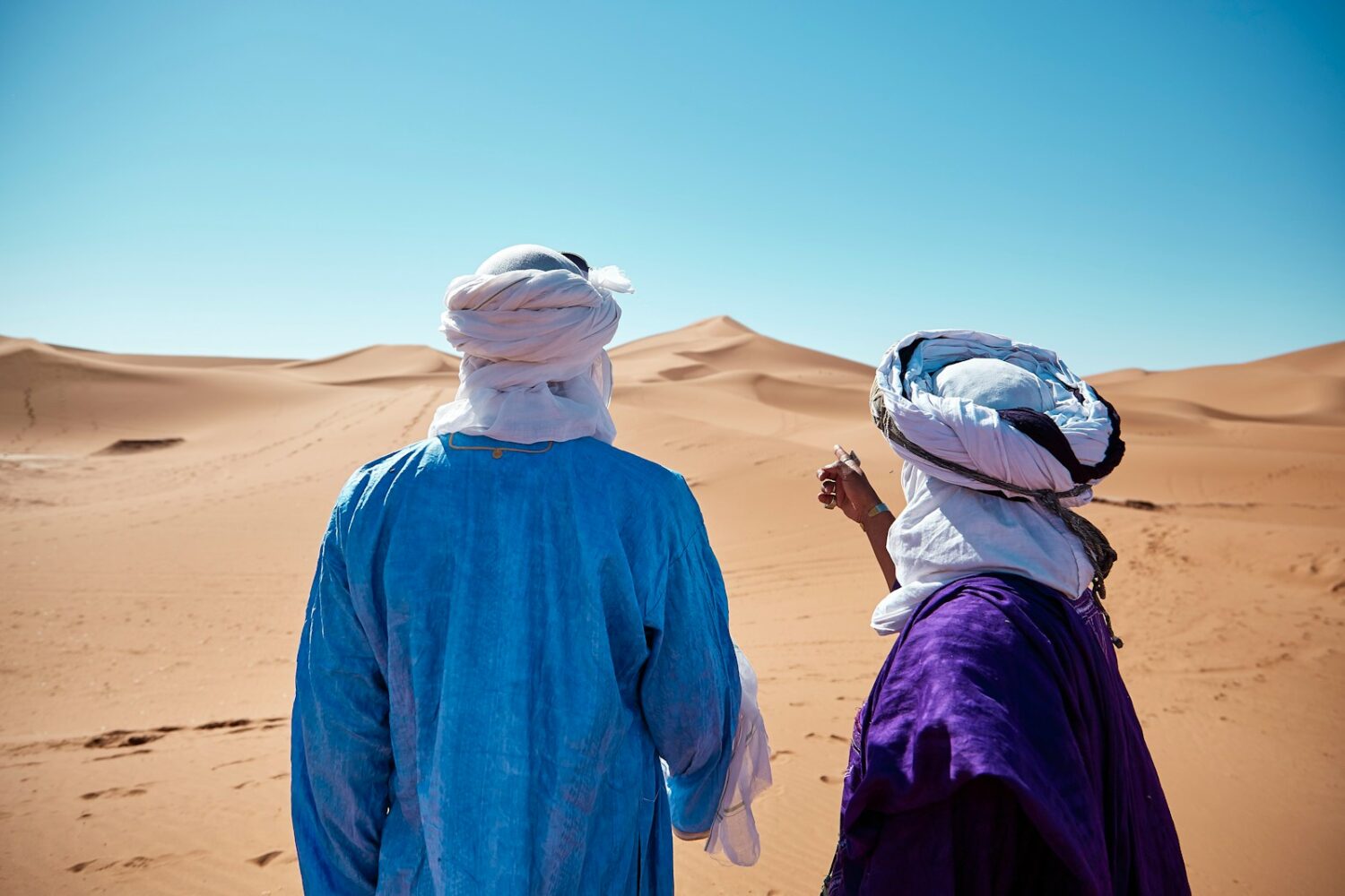 two persons standing on desert