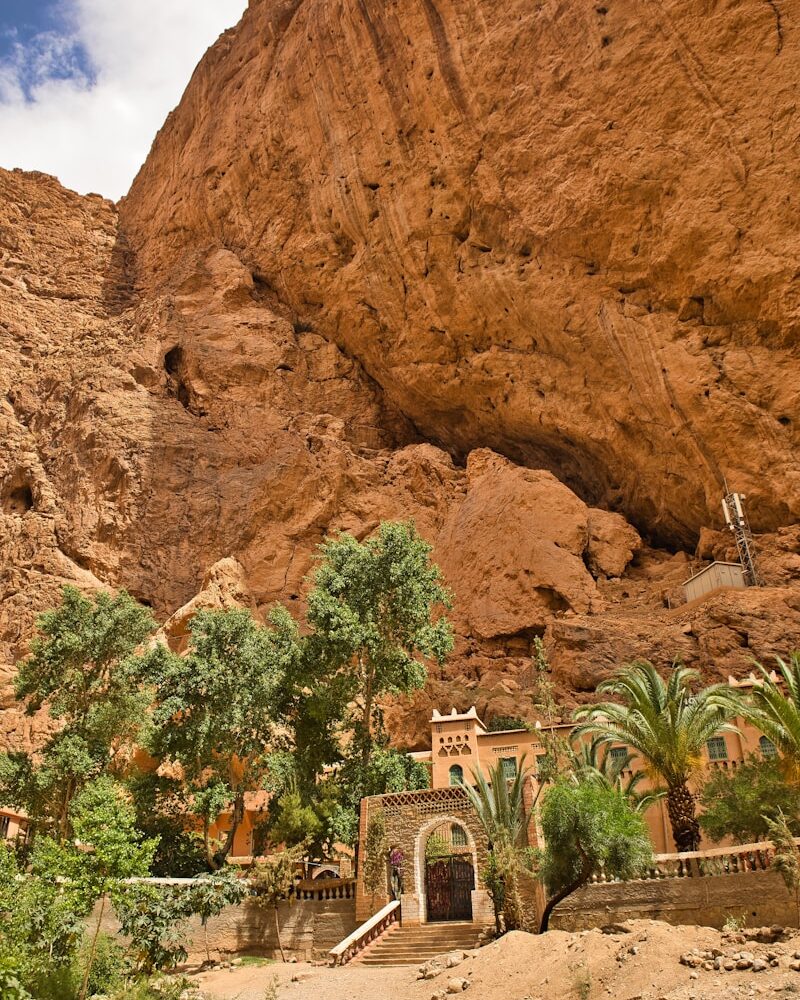 A large rock formation with a building in the middle of it