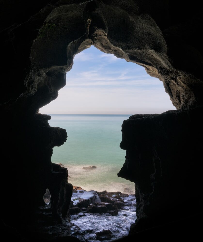 body of water near cave